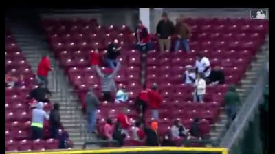 A spectator and his nachos fall down while watching a baseball game